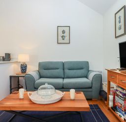 A living room with a sofa and coffee table at Hilldown Granary near Bow