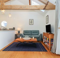 A living room with a sofa and coffee table at Hilldown Granary near Bow