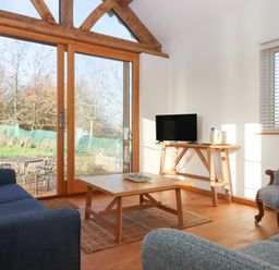 A living room with a sofa and table at Hilldown Cott near Bow