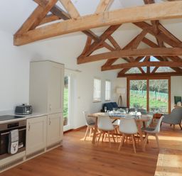 A dining room with a table and chairs at Hilldown Cott near Bow