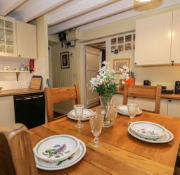 A dining room with a table set for four at Noddfa Penmachno