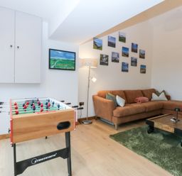 A living room with a foosball table and a sofa at Hen Penmynydd Llanfwrog near Llanfachraeth