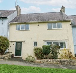 A house with a green door and windows at 16 Ffordd Meigan Beaumaris