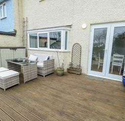 A garden area with seating and a table at 16 Ffordd Meigan Beaumaris