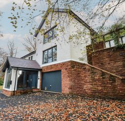 A house with a garage and steps at Chapel Hill in Catlowdy