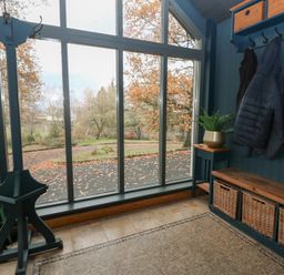 An entryway with coat rack and bench at Chapel Hill in Catlowdy