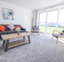 A living room with a sofa and coffee table at Seafern House 36B in Poole