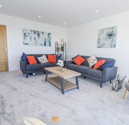 A living room with sofas and a coffee table at Seafern House 36B in Poole