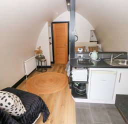 A studio with a kitchenette and bed at Cwtch Bach in Aberdare