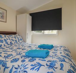 A bedroom with a bed and wardrobe at Stanbury in St Merryn