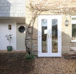 An outdoor area featuring a door, window, and potted plant at The Mizzen in St Endellion near Port Isaac