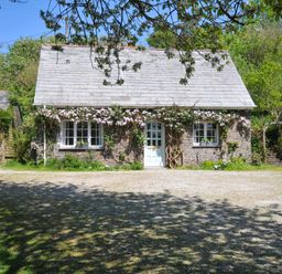 A house with a front door and windows at Copper Mine Cottage in Trelill near Port Isaac