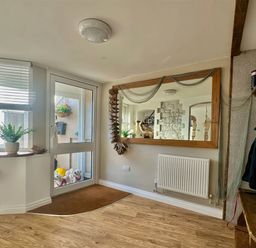 A hallway with a mirror and coat rack at 