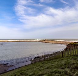 A view of a shoreline with water at Corner Cottage in Seahouses