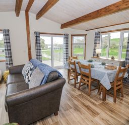 A dining room with a table and chairs at Willow Lodge Admaston near Abbots Bromley