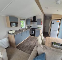 A kitchen with appliances and seating area at 