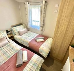 A bedroom with two beds and a window at the property in location