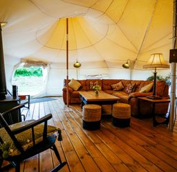 A living area with a sofa and coffee table in a tent