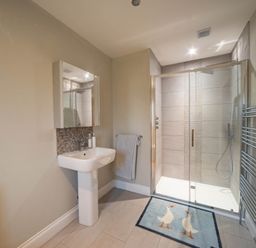 A bathroom with a shower and sink at The Old Barn in Manchester