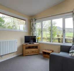 A living room with a sofa and television at The Old Barn in Manchester