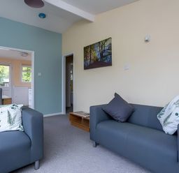A living room with two sofas and a table at The Old Barn in Manchester