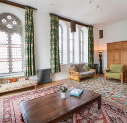 A living room with a sofa and coffee table at Capel Llani in Llanidloes