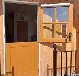 An entrance door with a clock visible at the property in