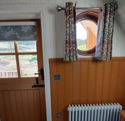 An entryway with a door and a round window at the property located in