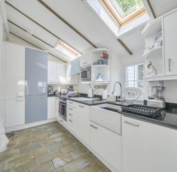 A kitchen with appliances and cabinets at Bwthyn Nain in Harlech