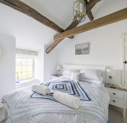 A bedroom with a bed and nightstand at Bwthyn Nain in Harlech
