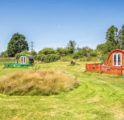 Two glamping pods in a grassy area at St Austell Glamping St Austell