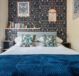 A bedroom with a bed and bookshelf at 20 Main Street in Heysham