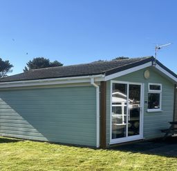 A cabin with a table and seats outside at Embury 