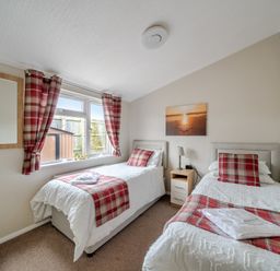 A bedroom with two beds and a nightstand at 311 in Bridlington