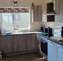 A kitchen with cabinets, sink, and appliances at 50 Bridlington