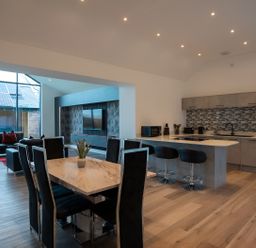 A kitchen with a dining table and seating area at The Shearling in Morpeth