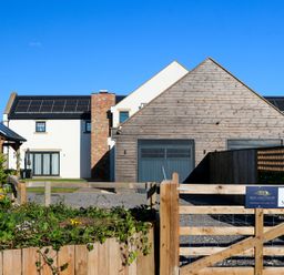 A house with a garage and solar panels at The Newland in Morpeth