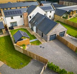 An outdoor view of buildings and a garden at The Newland in Morpeth