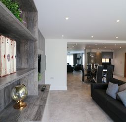 A living room with a television and dining area at The Gavel in Morpeth