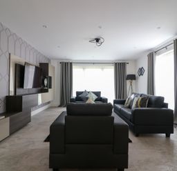 A living room with a television and sofas at The Gavel in Morpeth