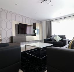 A living room with a television and coffee table at The Gavel in Morpeth