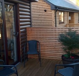 An outdoor area with chairs and a planter at Gowrie Lodge Blairgowrie