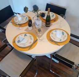 A dining table set with plates and glasses at Gowrie Lodge in Blairgowrie