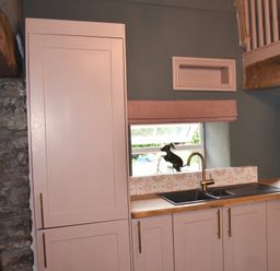 A kitchen with cabinets and a sink at Ty Llaeth in Carmarthen