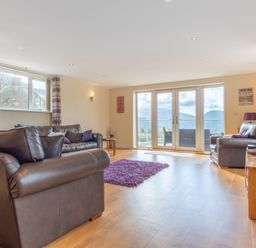A living room with a sofa and coffee table at Groeslon Uchaf in Caernarfon