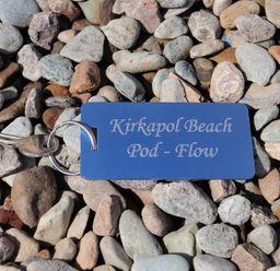 A key and tag on pebbles at Kirkapol Beach Pod - Flow Isle of Tiree