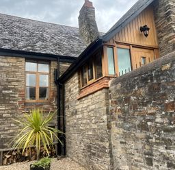 An exterior view of a stone house with a plant in front at 4 Bickington Road Barnstaple