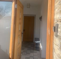 An entrance hall with a coat rack and console table at 4 Bickington Road Barnstaple