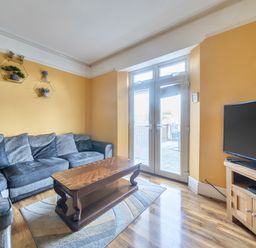 A living room with a sofa and television at Sea View Escape in Penmaenmawr