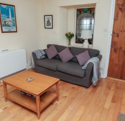 A living room with a sofa and coffee table at Sunny Brae in Alnwick